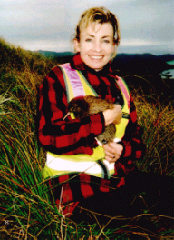 Image of a woman holding a kiwi